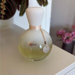 Lacoste Round Perfume Bottle in Pale Yellow & Clear